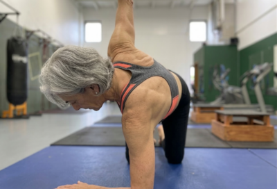 Woman performing a thoracic rotation